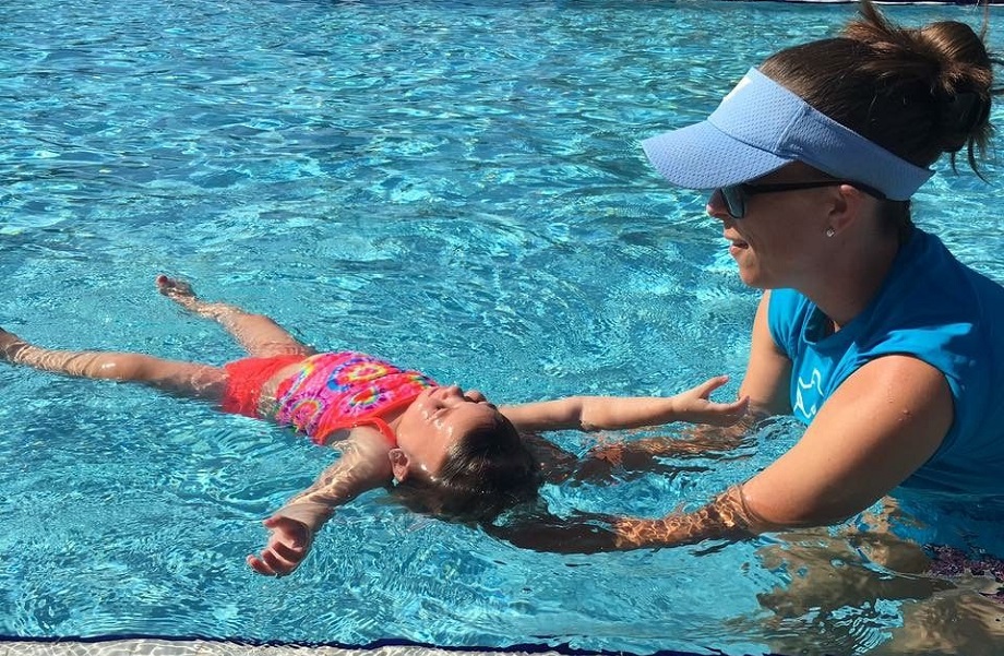 Toddler floating on back during her Safe Start drowning prevention swim lesson at the YMCA of Central Florida