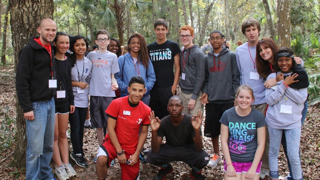Teenagers and camp counselors outside at camp