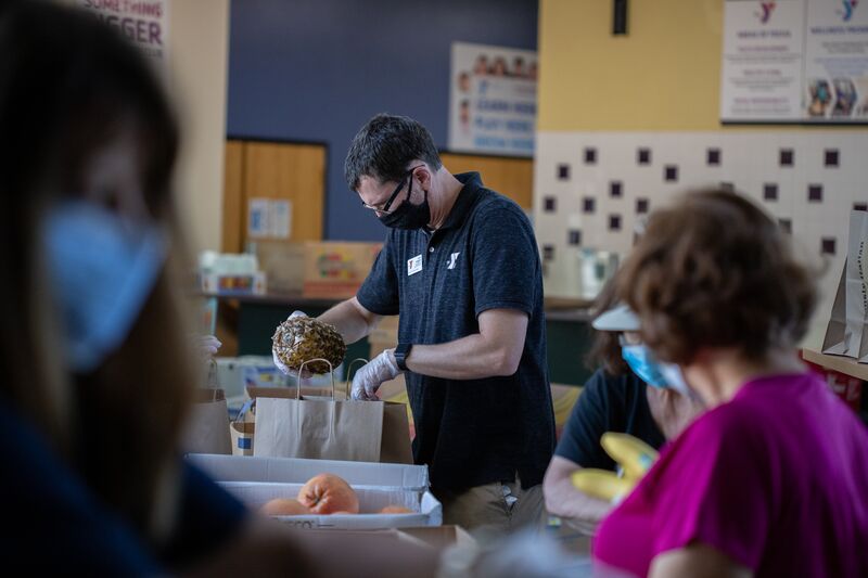 Volunteer Packing Food for Food Distribution