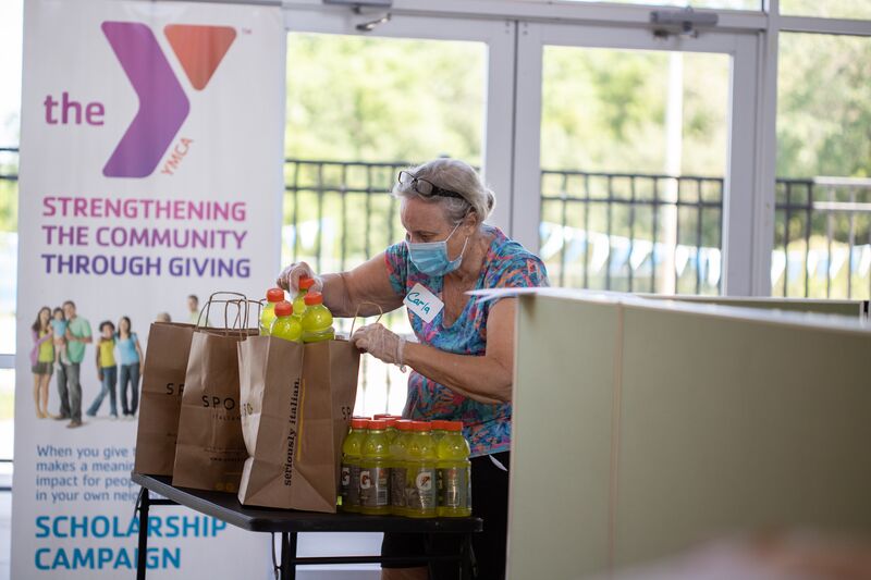 Volunteer Packing Drinks for Food Distribution