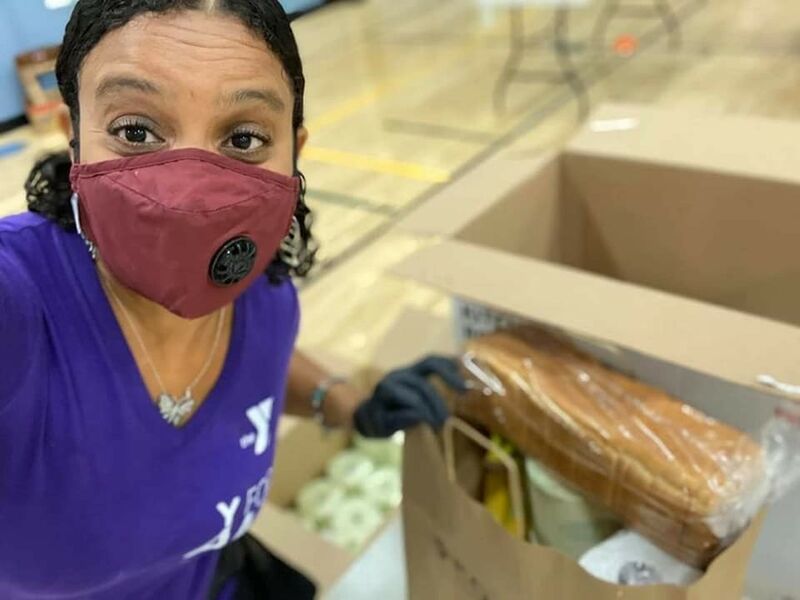 Volunteer Packing Supplies at Food Distribution Event at Titusville YMCA