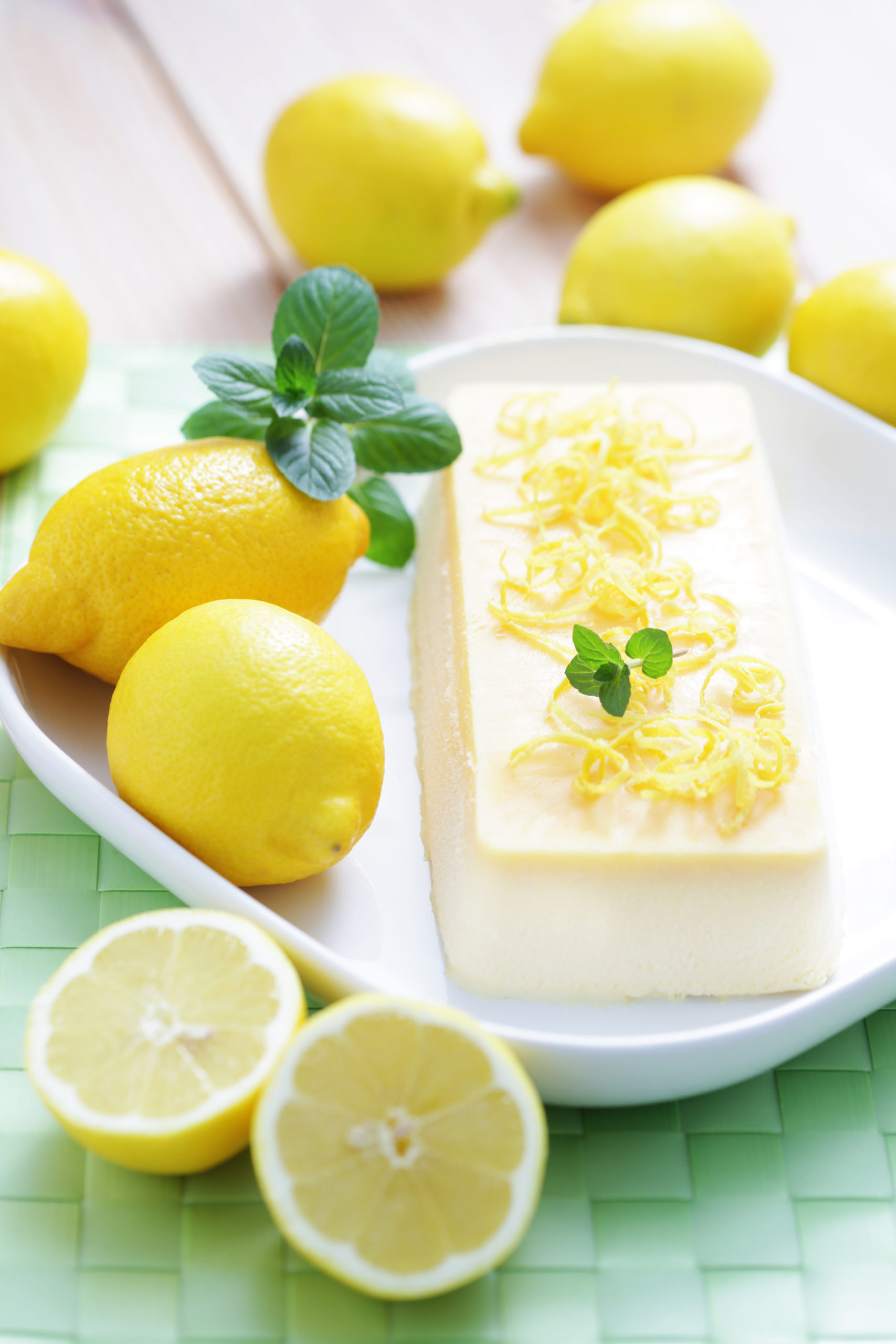 Lemon Ginger Semifreddo on white plate with lemons surrounding