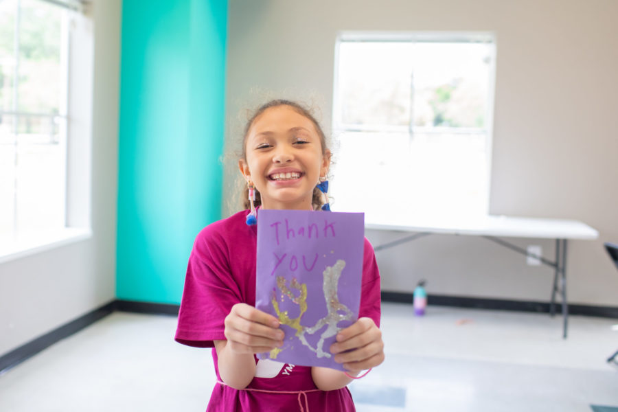 Child Holding up a Thank You Card