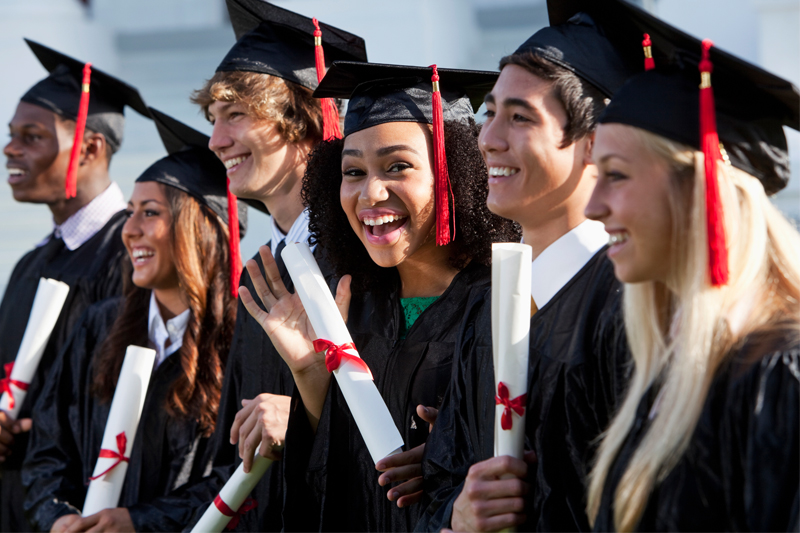 Group of high school graduates wearing caps and gowns