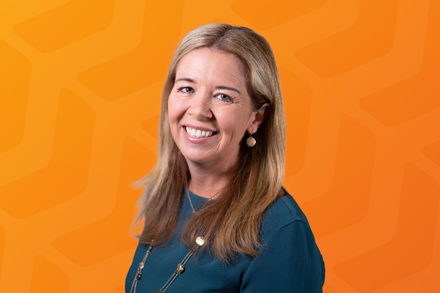 Headshot of Jody Alexander in front of orange chevron background