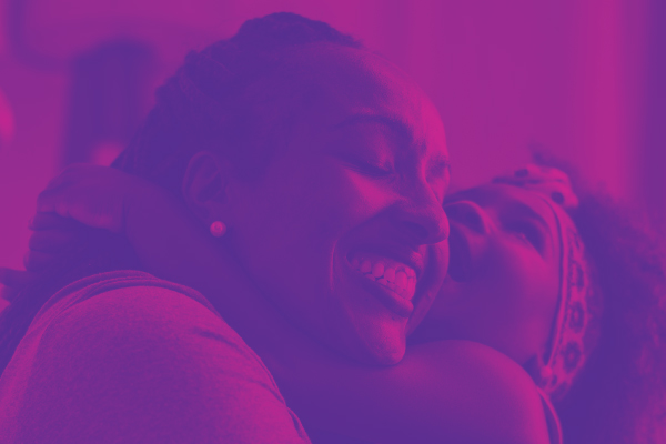 Image of mom hugging daughter that is artistically styled in light and dark purple tones