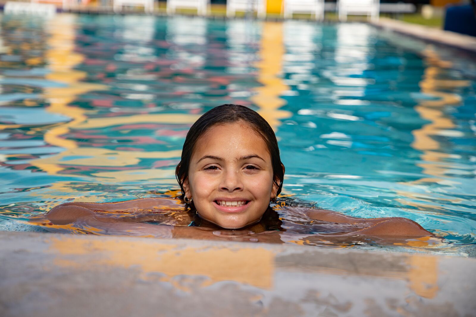 Eliana swimming in YMCA swimming pool