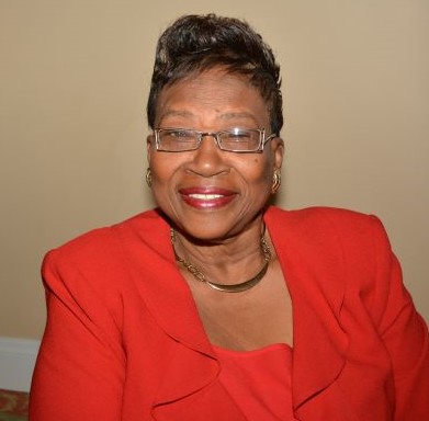 Headshot of Dr. Clara Walters in a red dress