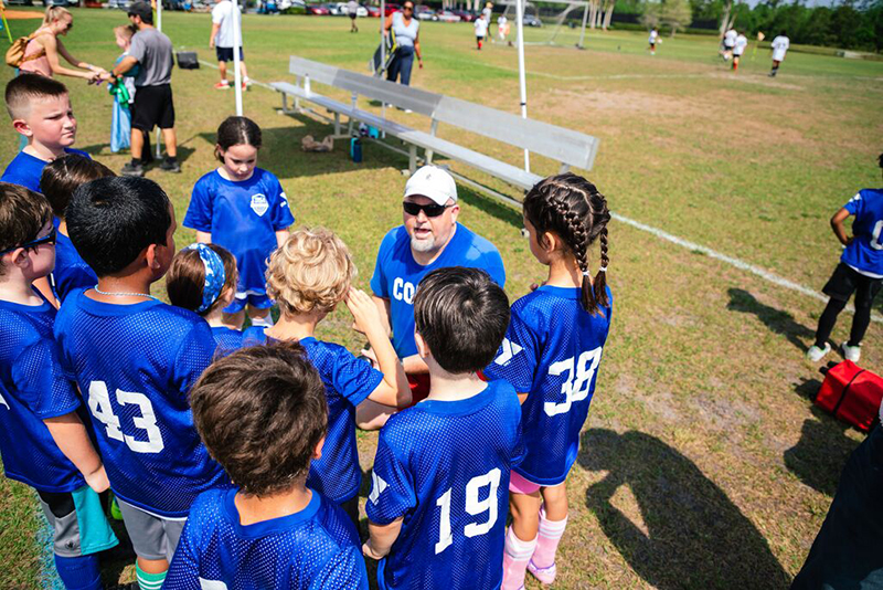YMCA Coach and Team Huddle