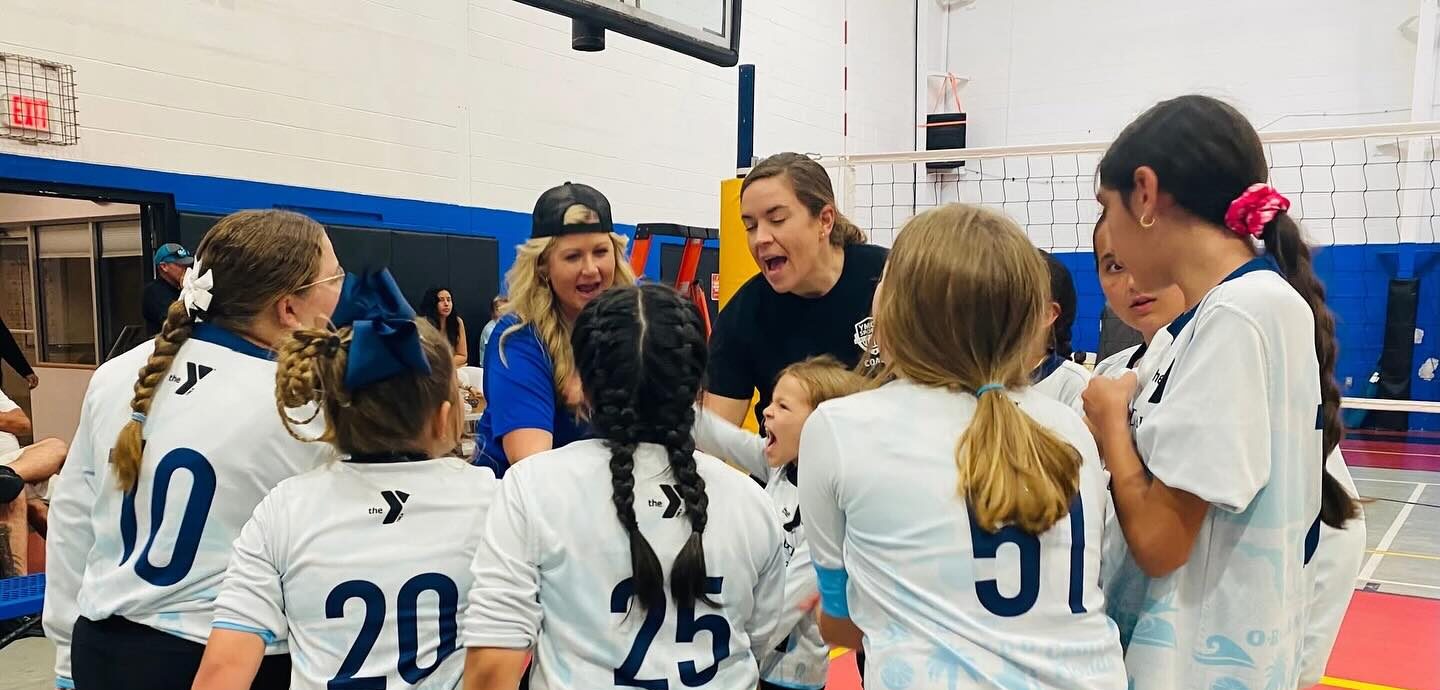Volleyball team huddle during a tournament at the Golden Triangle YMCA