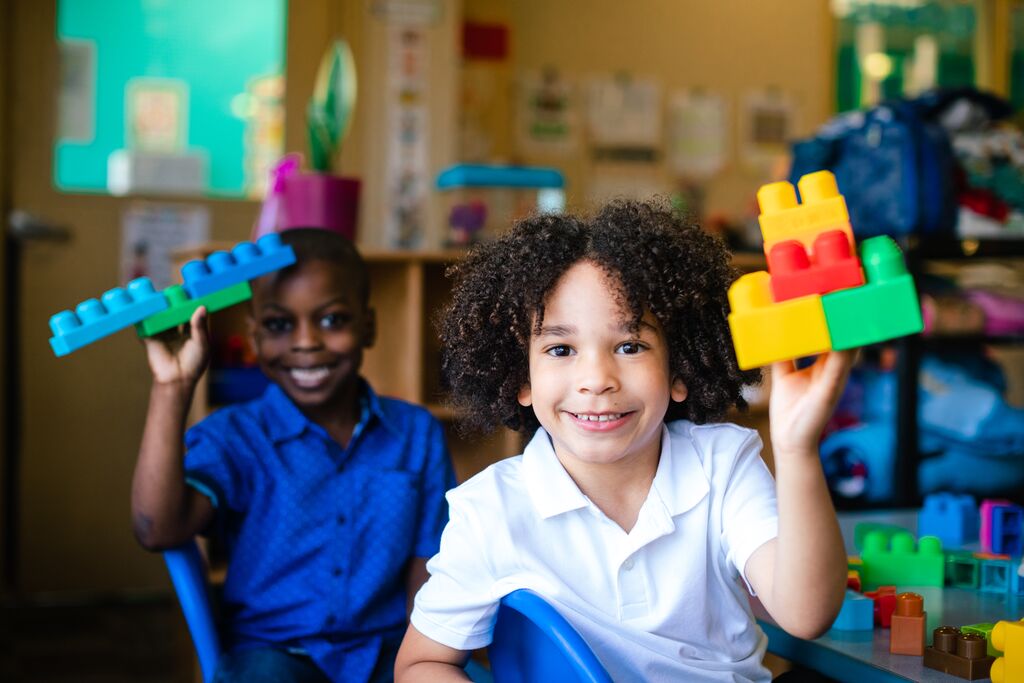 Boys showing off their Lego builds at the Osceola County YMCA Learning Center