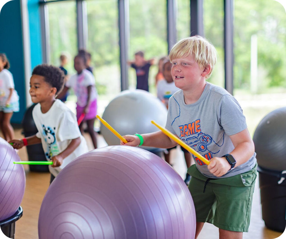 Boys drumming and dancing during Drum It, Dance It, Rock It class at Leonard & Marjorie Williams YMCA