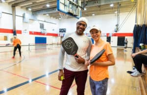 Couple posing for the camera during a pickleball tournament at the Orlando YMCA